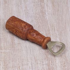 a bottle opener with a wooden handle on a table