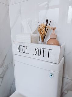 a white toilet sitting in a bathroom next to a bottle and soap dispenser