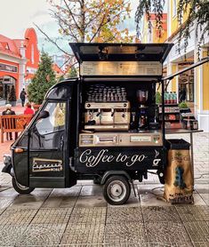 an old fashioned coffee truck parked on the street