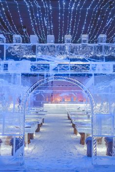 an ice sculpture with benches and lights in the background