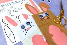 paper bunny printables and scissors sitting on top of some crafting material with holes in them