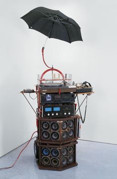 an umbrella that is sitting on top of a speaker