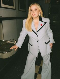 a woman in a suit posing for a photo