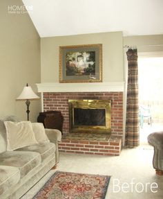 a living room with a couch, fireplace and rug in front of the fire place