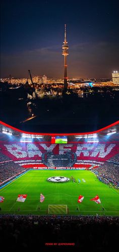 the stadium is lit up at night and there are many people on the field playing soccer