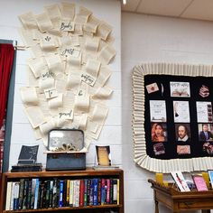 there is a bulletin board on the wall next to a bookshelf with pictures