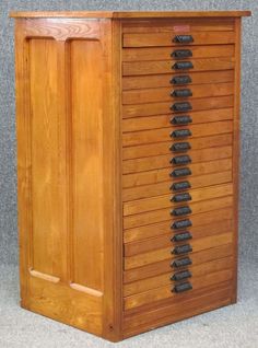 a wooden cabinet with many drawers on it