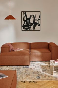 a living room filled with furniture and a painting on the wall