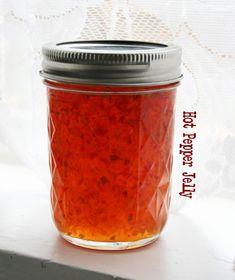 a jar filled with red liquid sitting on top of a table