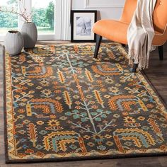 an area rug in a living room with orange chairs