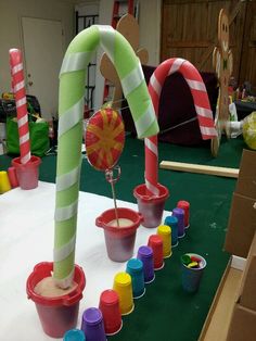 some candy canes and cups on a table