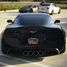 a black sports car parked in a parking lot