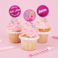 three cupcakes with pink frosting and one has a name tag on it