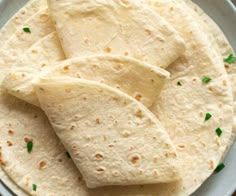 some tortillas are on a white plate