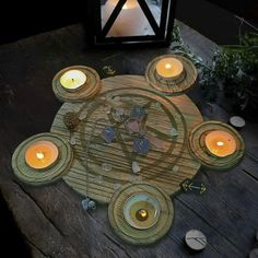 a wooden table topped with candles next to a lantern