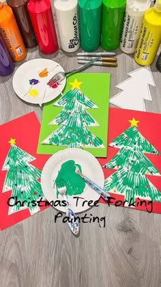 paper plates with christmas trees on them next to markers and crayon paint bottles