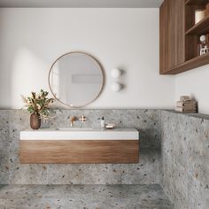 a bathroom with a sink, mirror and wooden cabinet in the corner next to it