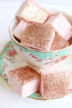 small pink and gold squares in a teacup