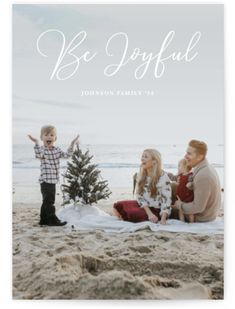 a family is sitting on the beach in front of a christmas tree and it says, wonders