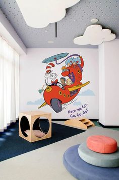 the children's room is decorated in white and blue colors with cartoon characters on it