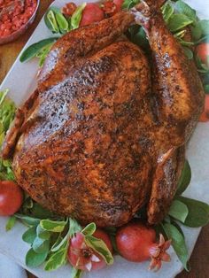 a roasted turkey on a platter with tomatoes and lettuce