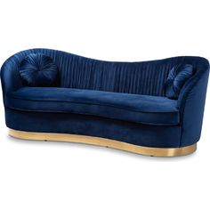 a blue velvet couch with gold trimmings on the arms and back, sitting in front of a white background