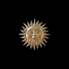 a gold sun face on a black background