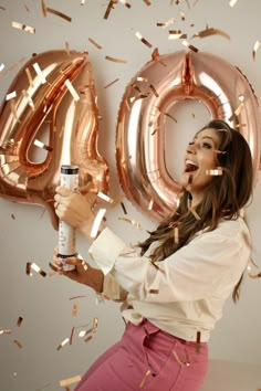 a woman holding a sprayer in her right hand and confetti around her