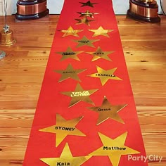 a red table runner with gold stars on it and some popcorn boxes in the background