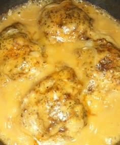 the meatballs are covered in gravy and melted cheese on the stove top