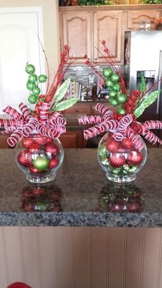 two glass vases filled with candy canes and ornaments