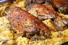 some meat is sitting on top of the food in the pan, ready to be eaten