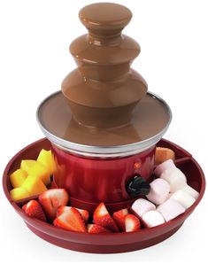 a chocolate fountain with fruit and marshmallows in the bottom, on a white background