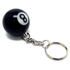 a black and white ball keychain with a number 8 on it