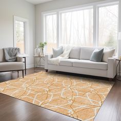 a living room filled with furniture and a yellow rug on top of a hard wood floor