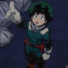 an anime character with green hair giving the thumbs up sign while standing in front of some garbage bags