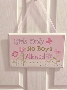 a sign hanging from the side of a door that says girls only no boys allowed