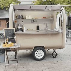 an outdoor food cart is parked on the sidewalk