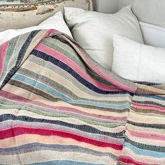 a bed with a striped blanket on top of it