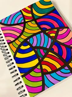 a spiral notebook with an abstract design on it