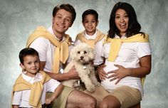 the family is posing for a photo with their dog and two children in matching outfits