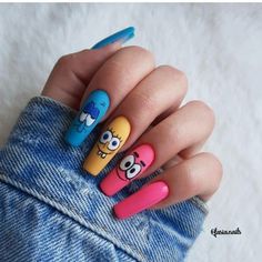 someone is holding their hand with some cartoon nail art on it's fingers and the nails are painted in different colors