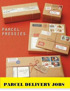 four wrapped packages with stamps on them sitting on an orange surface