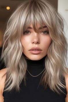 5. Platinum Shag with Fringe This platinum shag haircut features a bright, icy blonde shade that adds a striking contrast to the choppy layers and textured waves. The full fringe enhances the face, drawing attention to the eyes while maintaining a modern, chic vibe. Ash Blonde Hair With Fringe, Bangs With Shag Haircut, Long Modern Shag With Bangs, French Fringe Bangs Round Face, Rocker Fringe Hair, Long Platinum Hair With Bangs, Blonde Lob With Fringe, Long Shag Haircut Blonde, Platinum Shag Hair