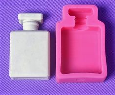 an empty bottle next to a plastic container on a purple surface with a white top