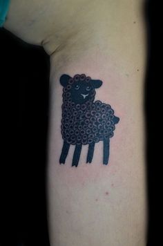 a black sheep tattoo on the left arm