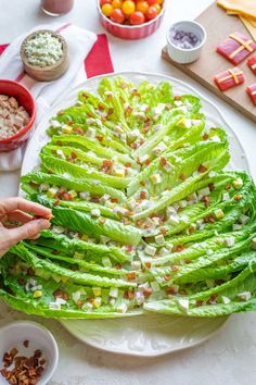 lettuce leaves are arranged in the shape of a christmas tree on a plate