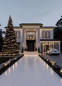 a large white house with christmas lights on it's front door and trees in the driveway