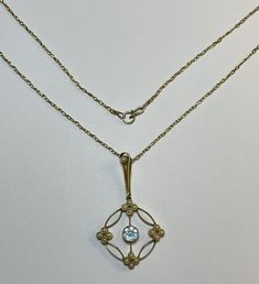 Art Deco Necklace. This antique 15 carat gold pendant necklace exudes the elegance of the Art Deco era, with a central round cut aquamarine set in a geometric circular flower design. At the quarters of the pendant are little flower motifs made from 4 petite pearls. There is another pearl set into the feature length bale. The pendant hangs from a 9ct yellow gold chain.  The pendant is a perfect gift for any occasion, whether it's Mother's Day, Christmas, Graduation, Anniversary, Birthday, or Vale Antique Jewelry Necklace, Flower Motifs, Necklace Art, Aquamarine Pendant, Art Deco Necklace, Pearl Set, Art Deco Era, Yellow Gold Chain, Antique Jewellery