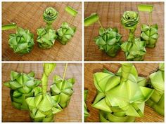 the process of making an origami flower with green leaves and stems on a wooden surface